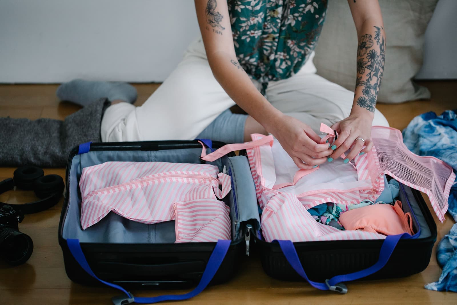Clothes and travel essentials being packed into a suitcase